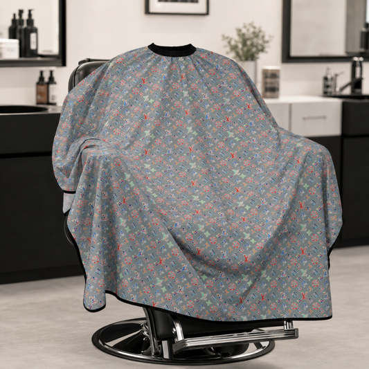 Multicolour grey barber cape draped over a black salon chair