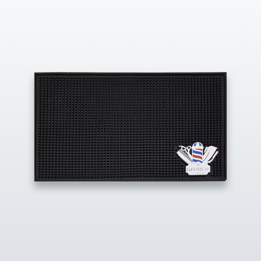 Black barber mat with barber-pole logo on a light-grey studio background