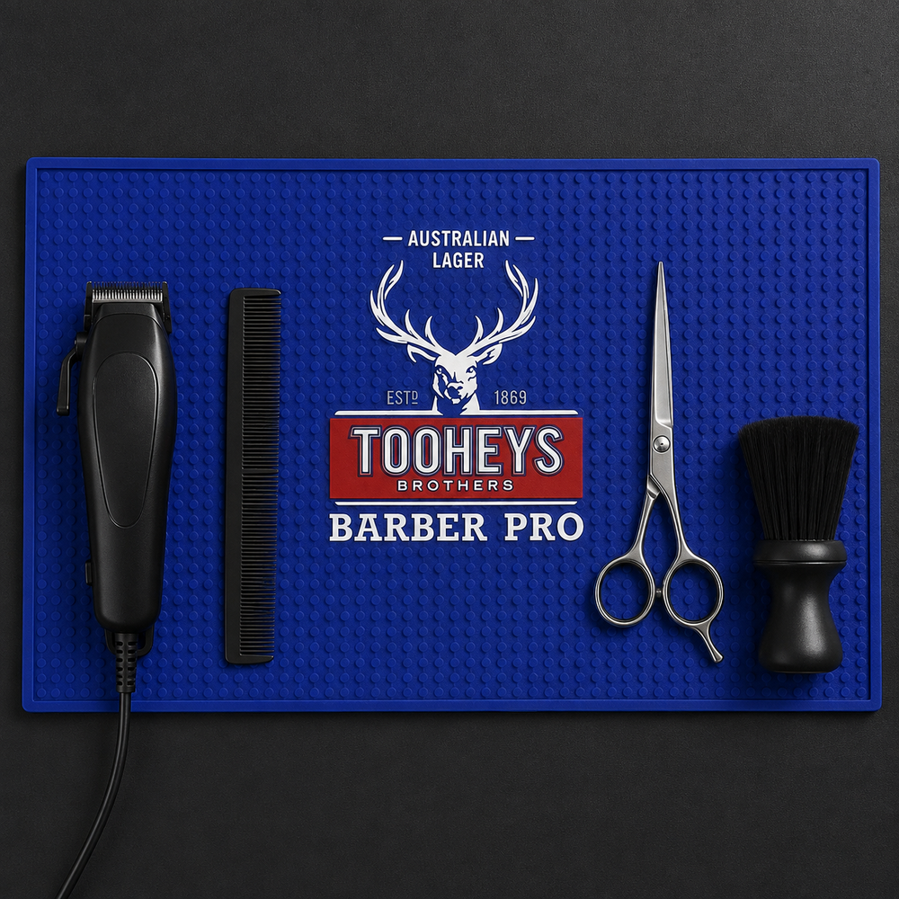 Top-down view of tools organised on the blue Tooheys Barber Pro mat