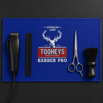 Top-down view of tools organised on the blue Tooheys Barber Pro mat