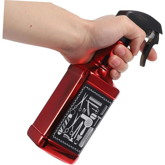Red barber water spray bottle held in hand