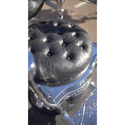 Chrome LV barber chair padded black checkered seat and reclining mechanism detail