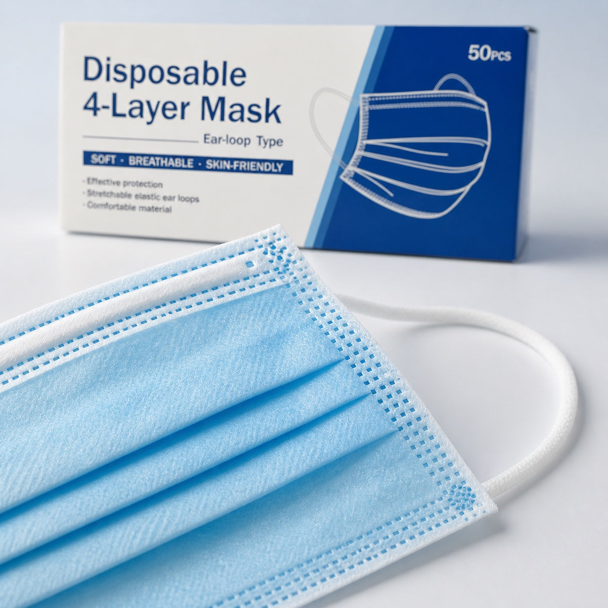 Close-up of blue disposable mask pleats and white ear loop