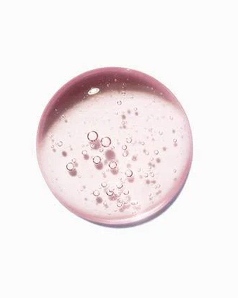Close-up of Kérastase Bain Riche Chroma Respect pink shampoo texture with bubbles