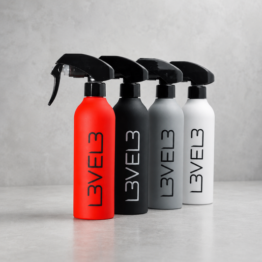 L3VEL3 rubberized spray bottles in red, black, grey and white on a light-grey studio background