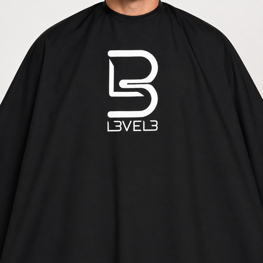 L3VEL3 black barber cape close detail showing white logo and matte fabric