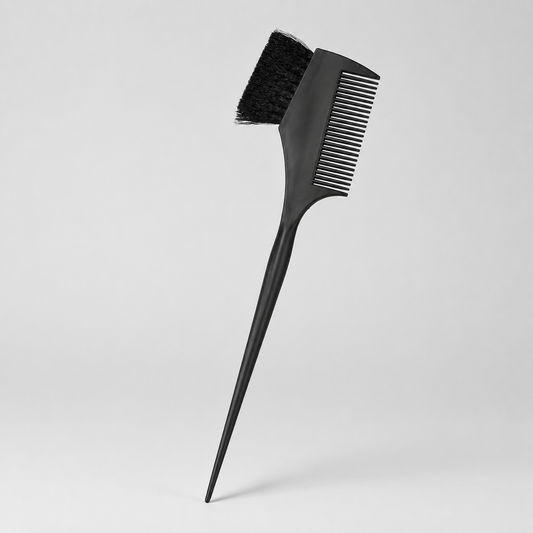 Black tint brush with comb and pointed sectioning tail on a light grey studio background