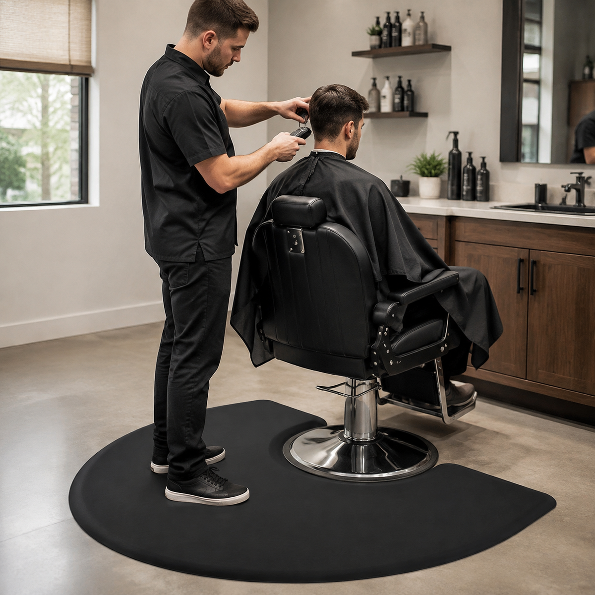 Barber standing on the black anti-fatigue mat while cutting a client’s hair