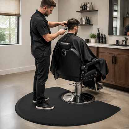 Barber standing on the black anti-fatigue mat while cutting a client’s hair