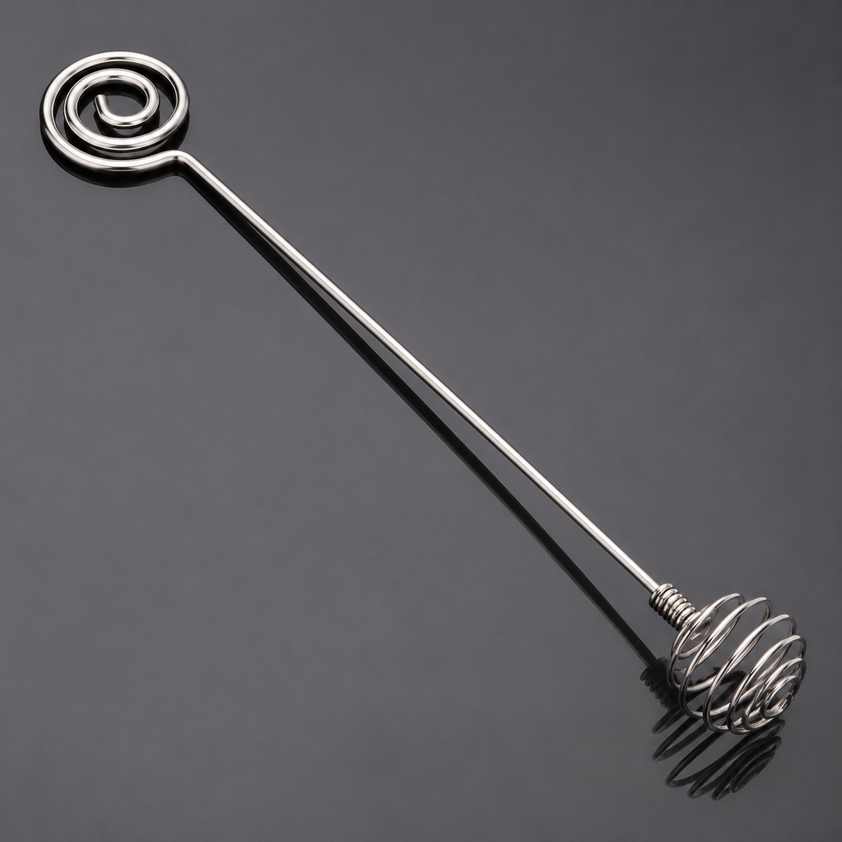 Close detail of the two spiral ends on a stainless steel mixing stick