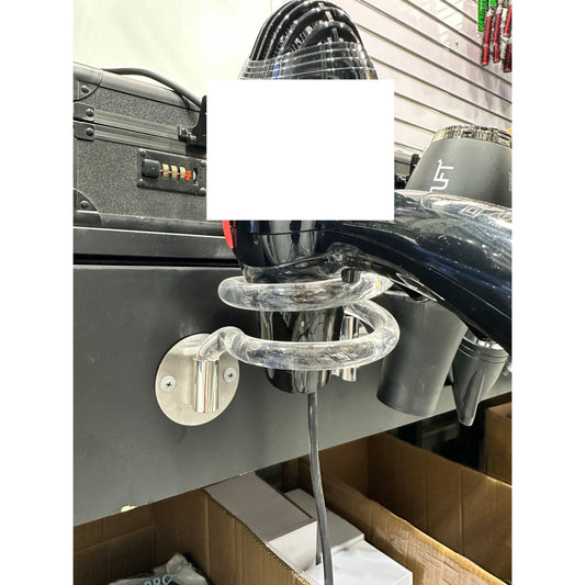 Clear wall-mounted hair dryer holder with open loops supporting a black salon dryer