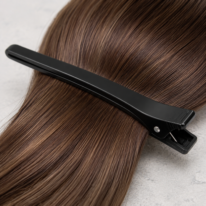 Close view of black hair clip jaws, pivot and ridged grip