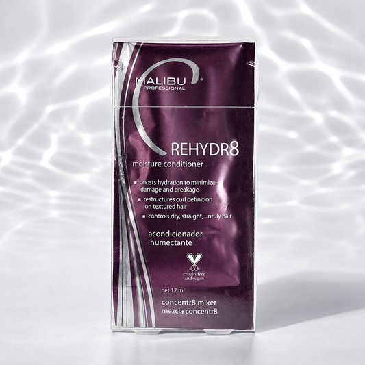 Malibu C Rehydr8 Moisture Conditioner 12ml sachet on a water-lit studio surface