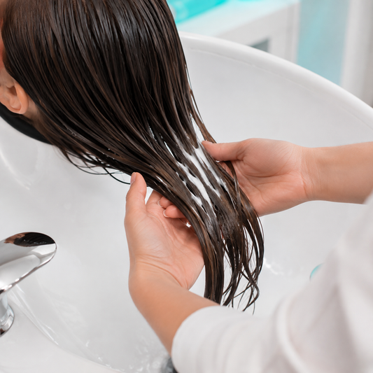 Malibu C Scalp Wellness Conditioner worked through wet hair at a salon basin
