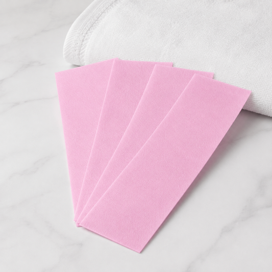Five pale pink Natural Look spun lace epilation cloth strips showing their non-woven texture