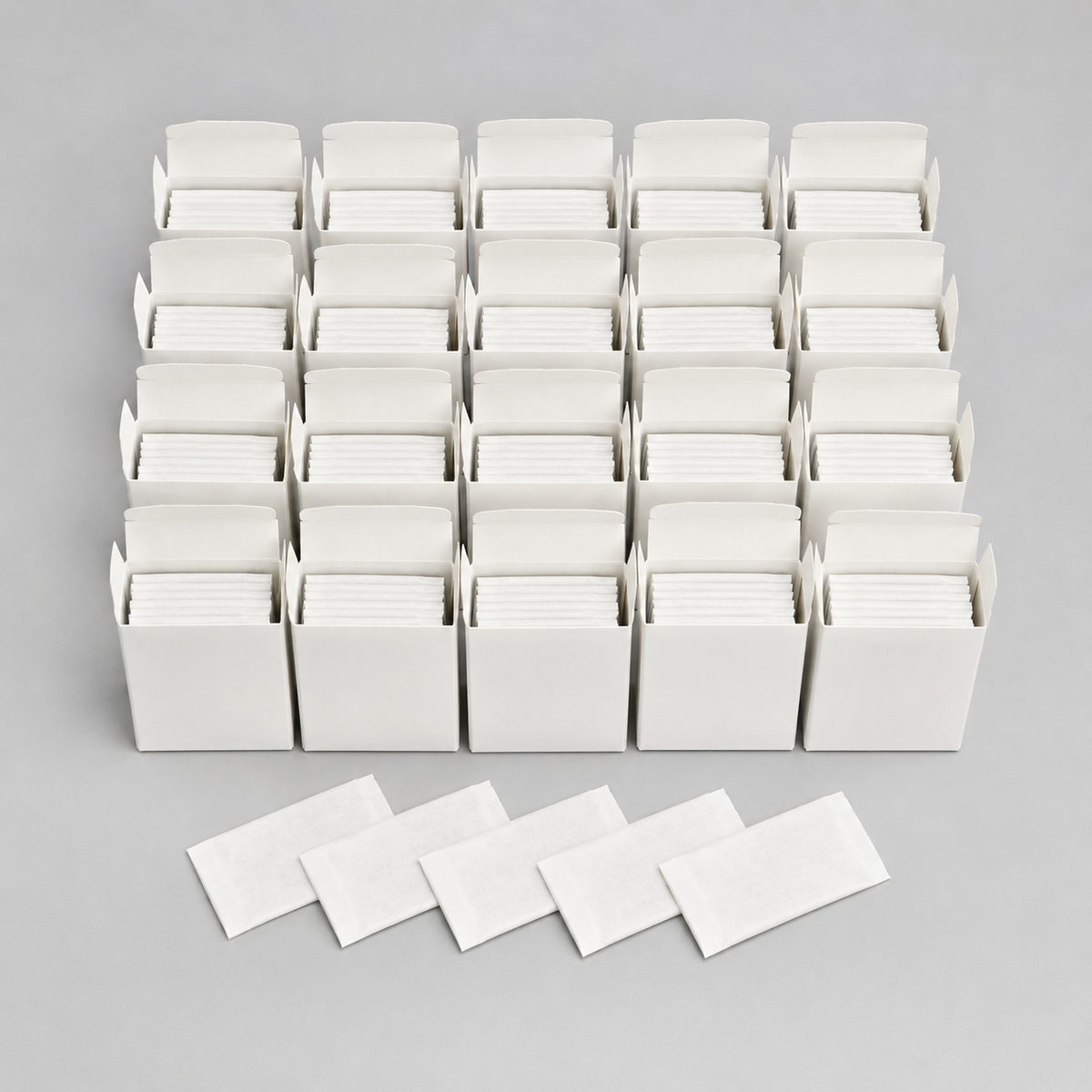 Twenty five-blade tucks and five wrappers representing the 100-blade pack
