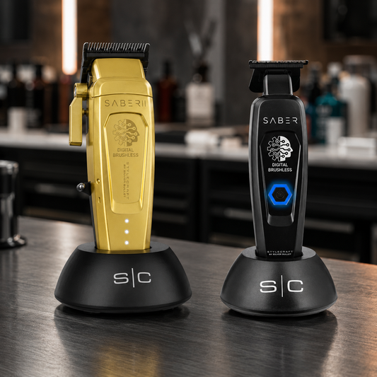 Gold Saber II clipper and black Saber precision trimmer on charging stands
