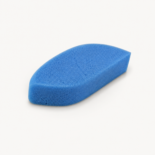 Titania ergonomic blue pumice sponge removed from packaging on a warm white studio background