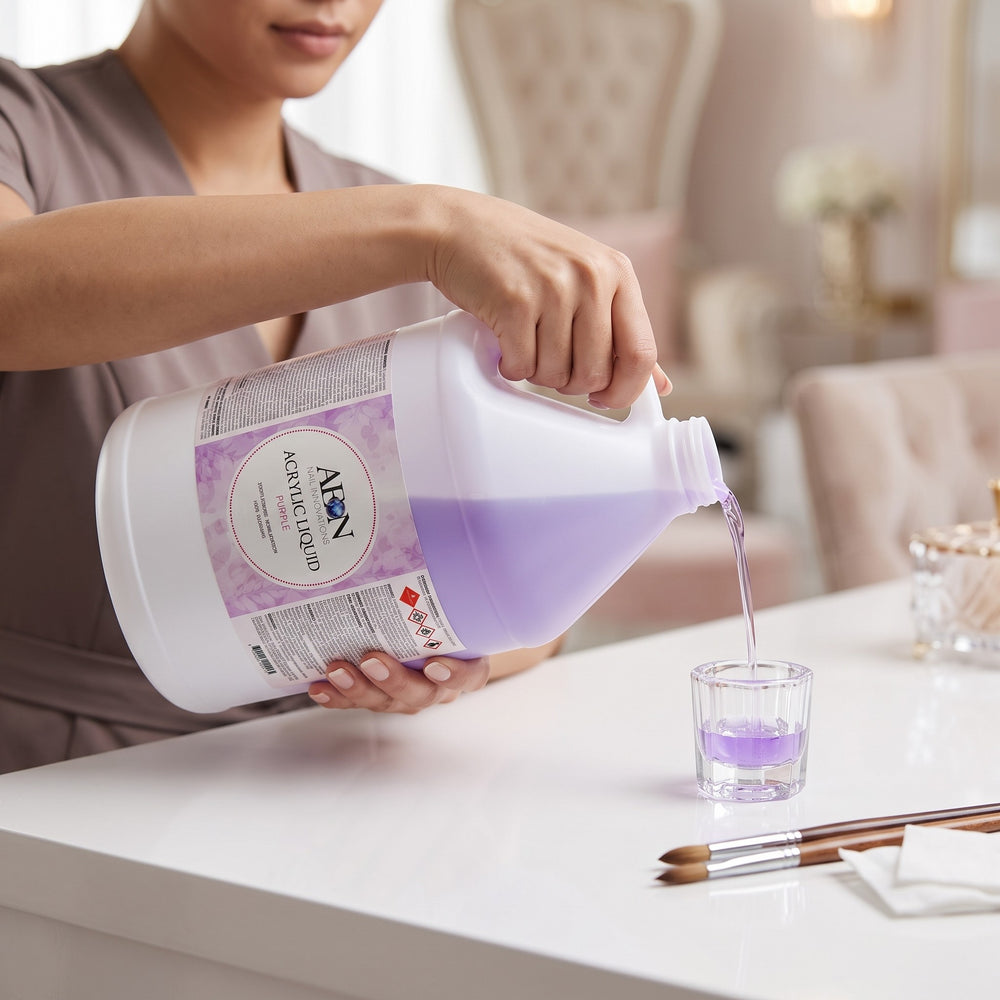 Nail technician pouring AEON acrylic nail liquid into a dish