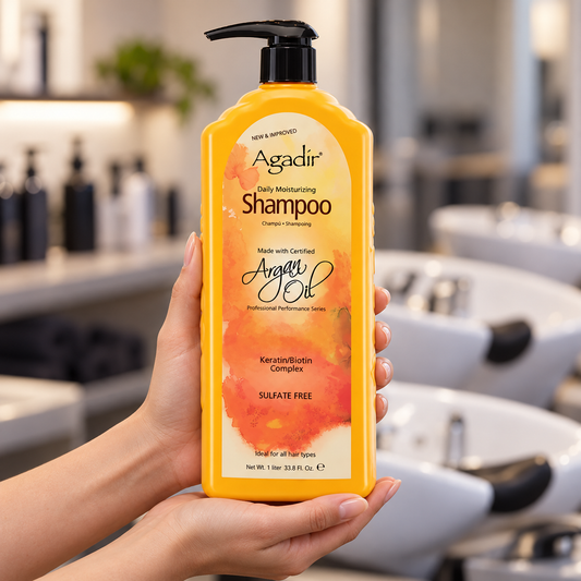 Agadir Argan Oil Daily Moisturizing Shampoo 1 litre bottle supported in two hands in a salon.