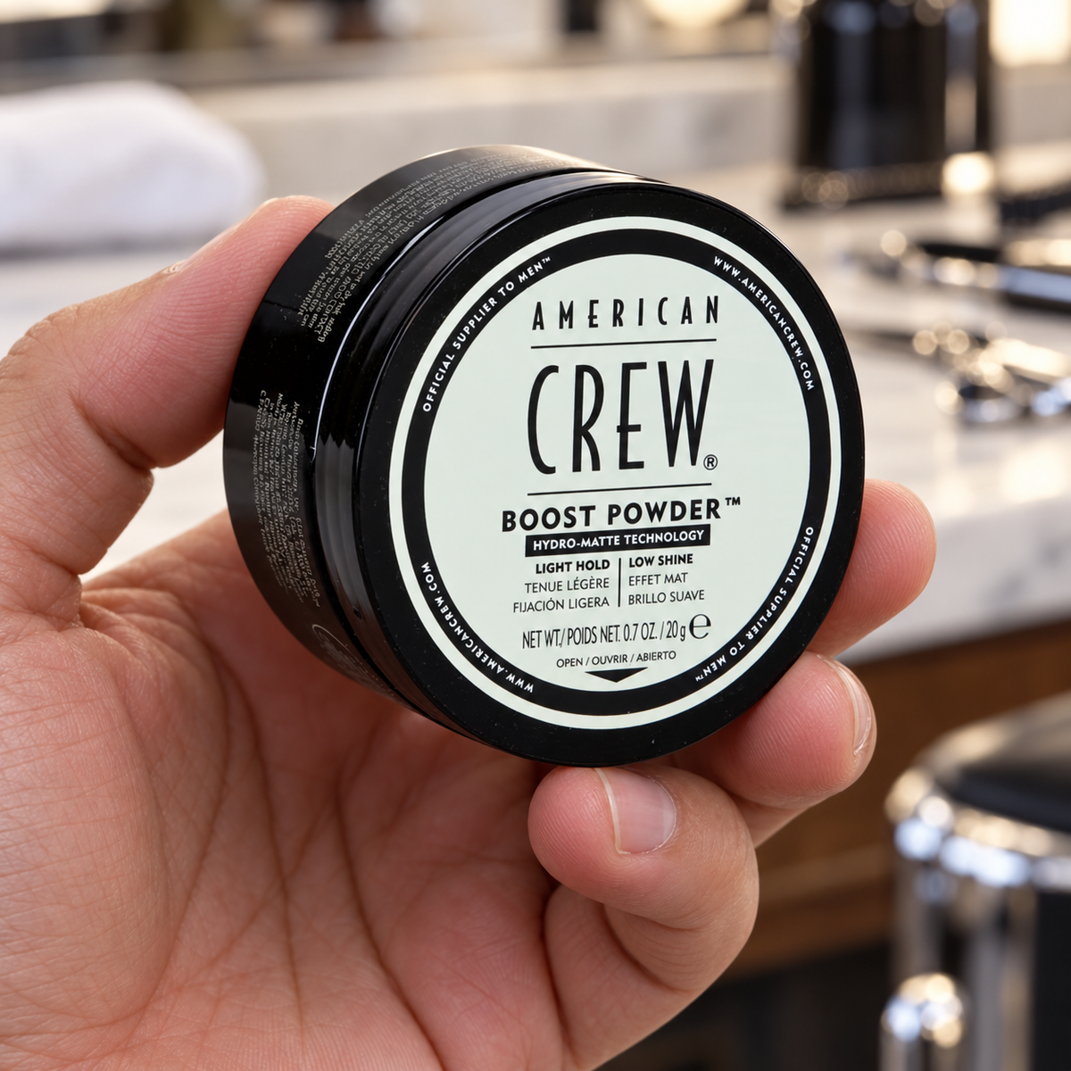 American Crew Boost Powder 20g closed tub held with the lid label facing forward