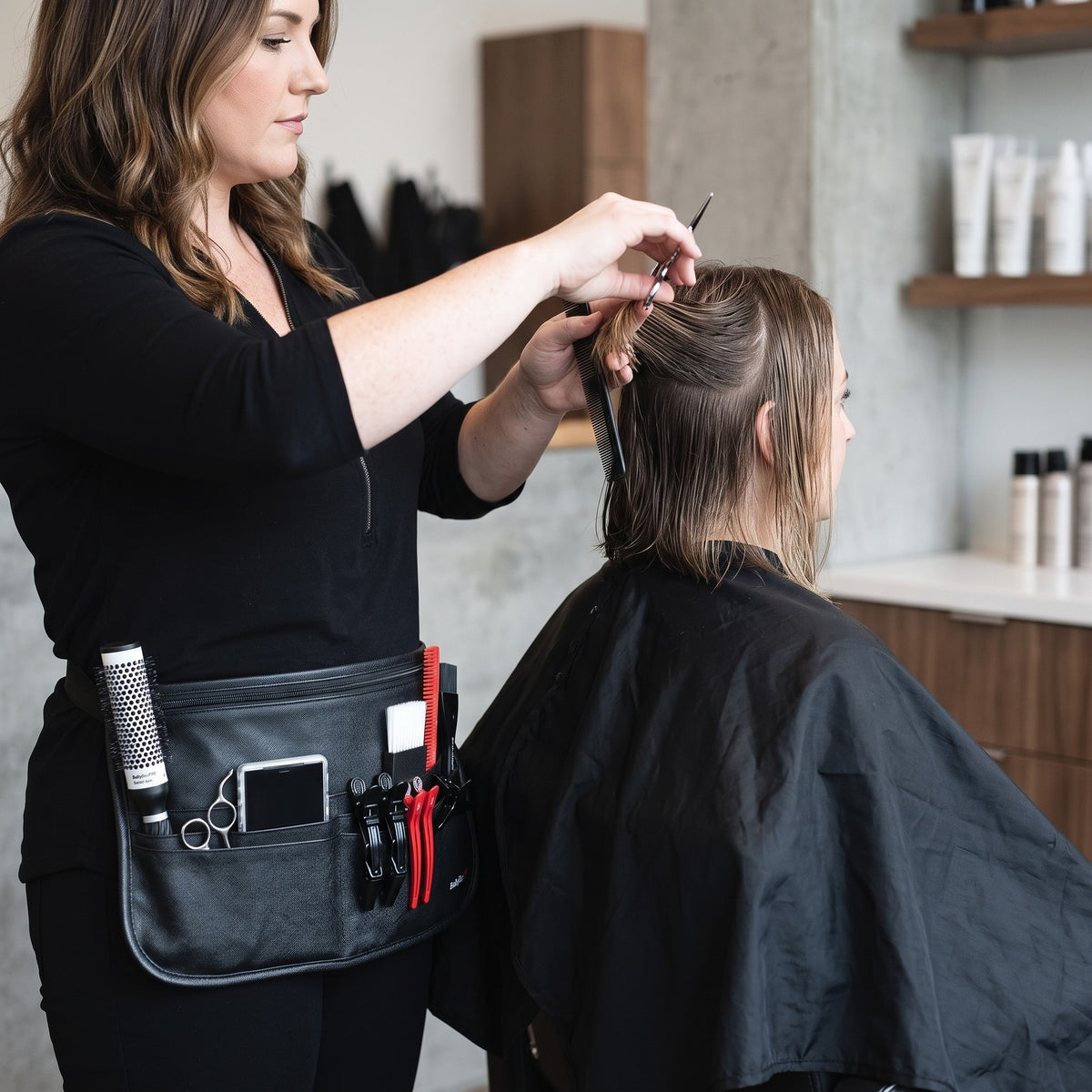 Stylist wearing the BaBylissPRO tool belt while cutting hair