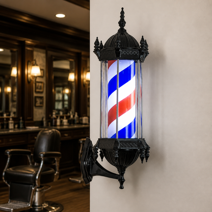 Black LED Rotating Barber Pole – Red, White & Blue displayed inside a premium barbershop