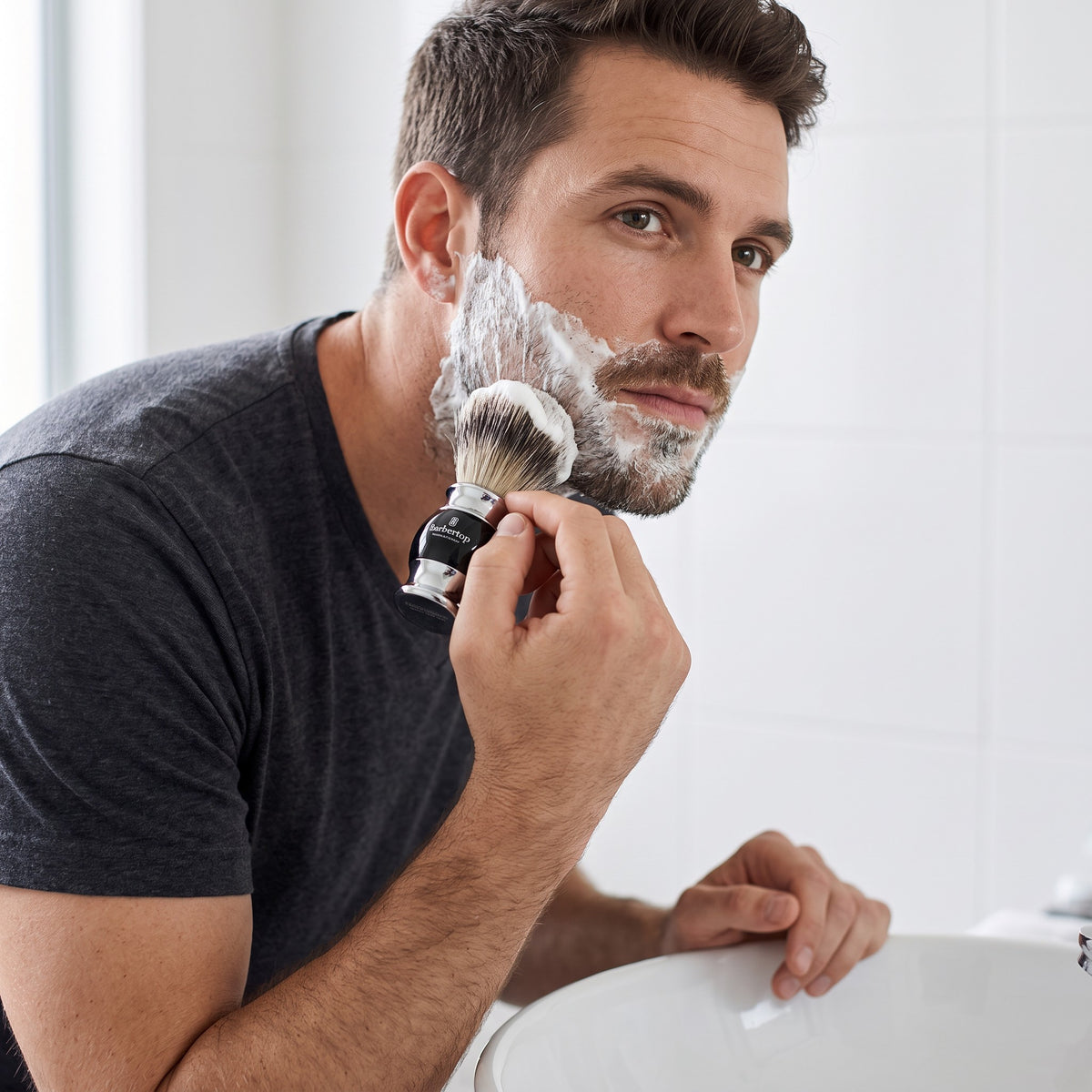Man lathering his face with the Barbertop shaving brush