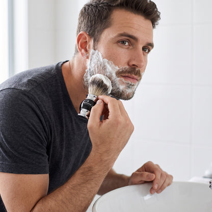 Man lathering his face with the Barbertop shaving brush