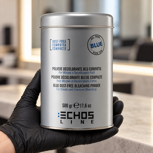 Echos Color Dust-Free Blue Bleach 500g held upright in a gloved hand in a salon, with the front label visible.