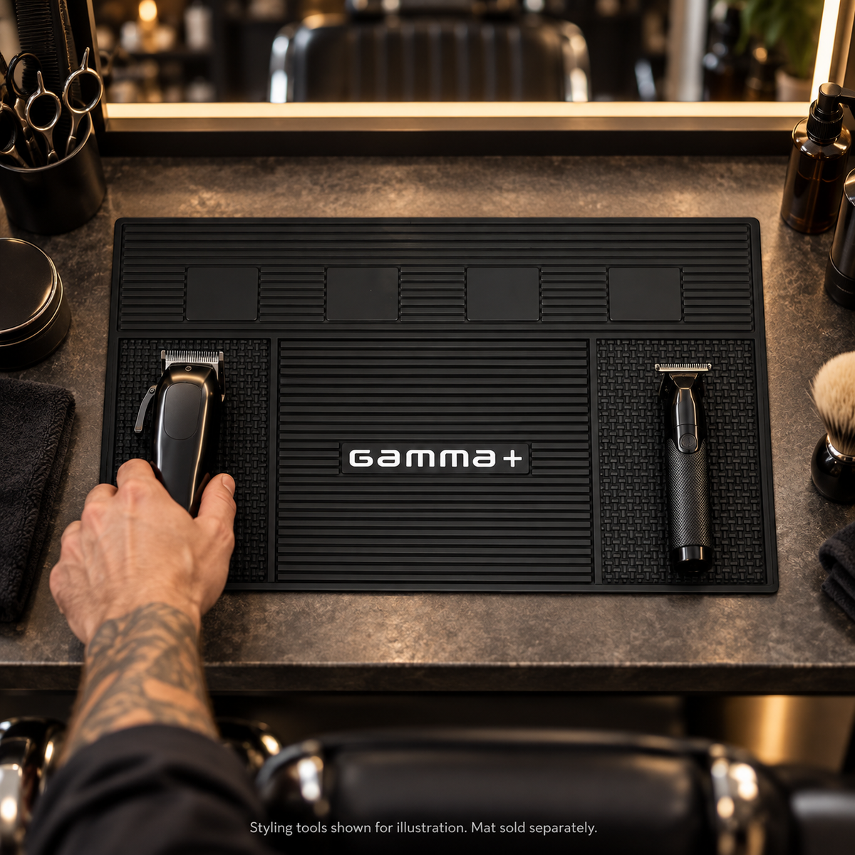 Illustrative barbershop workstation with a Gamma+ rubber mat supporting grooming tools; tools not included.