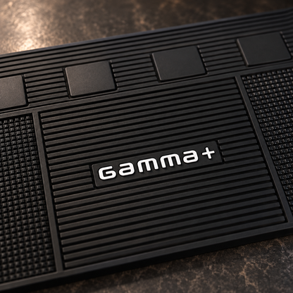 Close-up of the Gamma+ barber mat central grooves, logo and textured rubber.