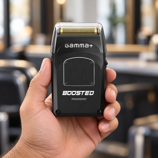 Gamma+ Boosted black foil shaver held in hand with its clear protective cap fitted