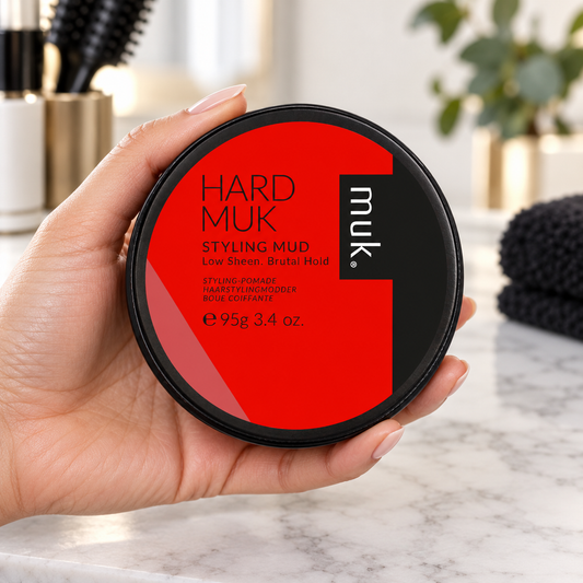 Hard muk Styling Mud 95g shown being handled at a salon station.