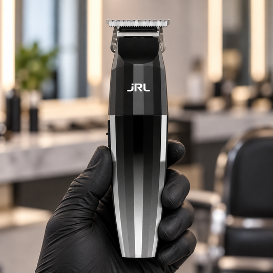 JRL 2020T silver trimmer held by its lower handle with the T-blade and front logo visible.