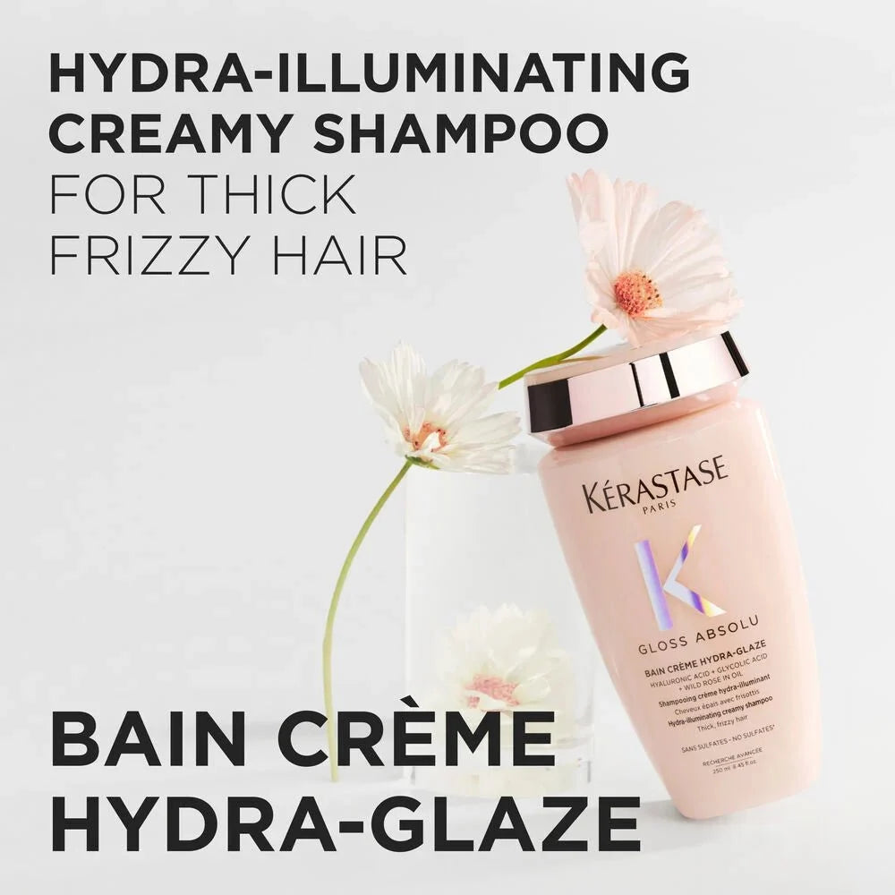 Kérastase Gloss Absolu Bain Crème Hydra-Glaze: hydra-illuminating creamy shampoo for thick, frizzy hair, shown with flowers