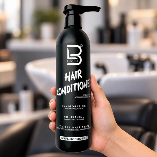 L3VEL3 Hair Conditioner 500ml pump bottle held upright at a salon wash station