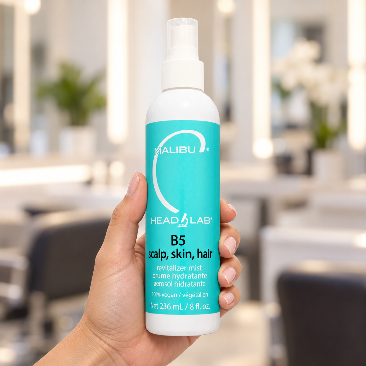 Malibu C B5 scalp, skin and hair revitalizer mist 236ml bottle held upright in a salon.