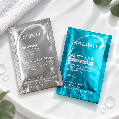 Close-up flat lay of the Malibu C Scalp Therapy 5g and Miracle Repair 12ml sachets.