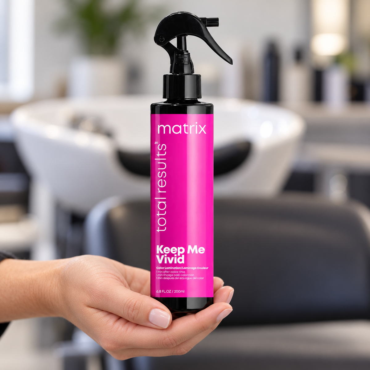 Matrix Keep Me Vivid Color Lamination Spray 200ml held upright at a salon wash station