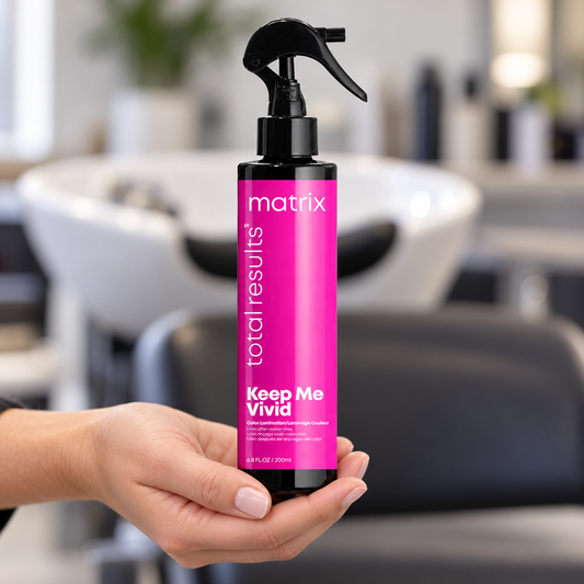 Matrix Keep Me Vivid Color Lamination Spray 200ml held upright at a salon wash station