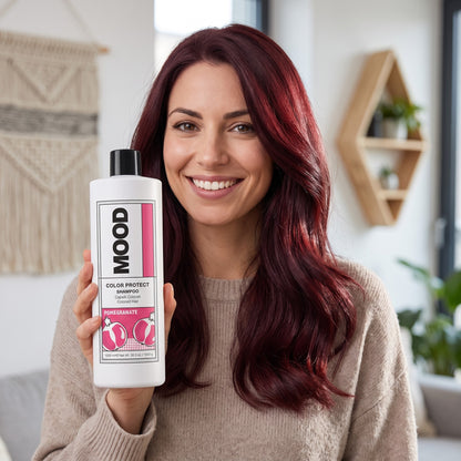Woman with red hair holding MOOD Color Protect Shampoo