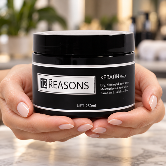 12 Reasons Keratin Mask 250ml held in hands with its closed lid and front label visible.
