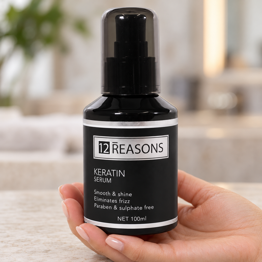 12 Reasons Keratin Serum 100ml held upright in a salon, with its cap and front label visible.