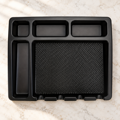 Black barber tools tray with five empty compartments on a salon workstation