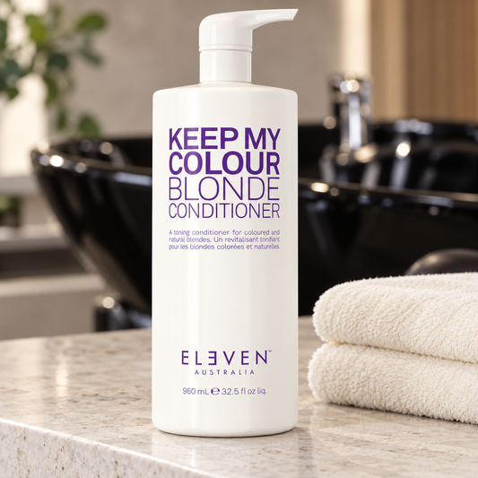 ELEVEN Australia Keep My Colour Blonde Conditioner 960 mL pump bottle at a salon wash station.