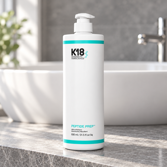 K18 Peptide Prep Detox Shampoo 930ml pump bottle beside a salon wash basin.