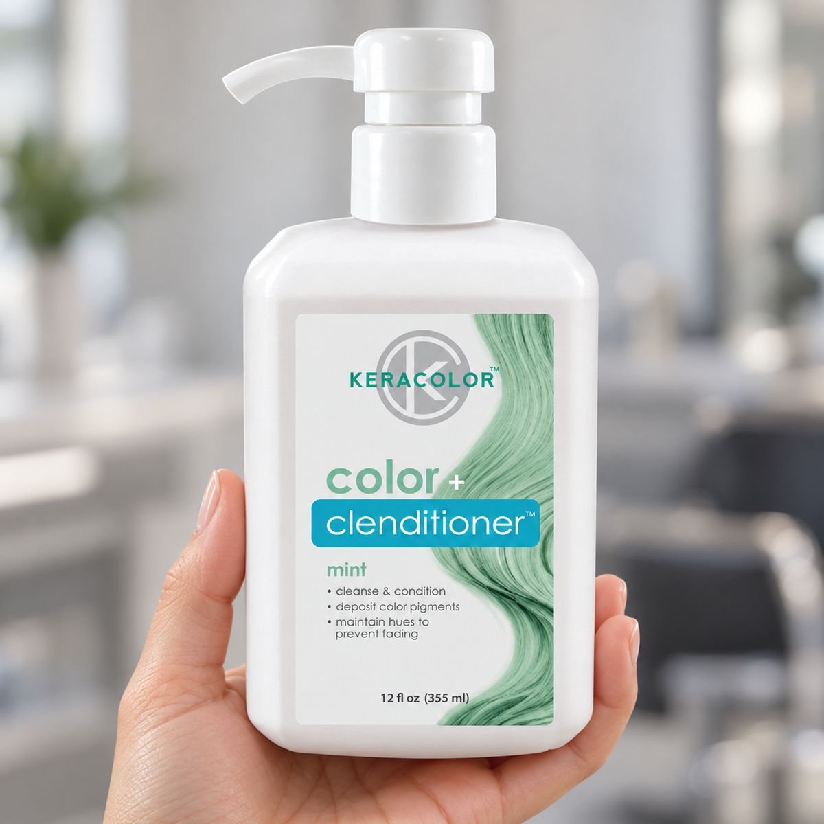 Keracolor Mint Color Clenditioner 355 ml bottle held in a salon, showing the mint-green front label.