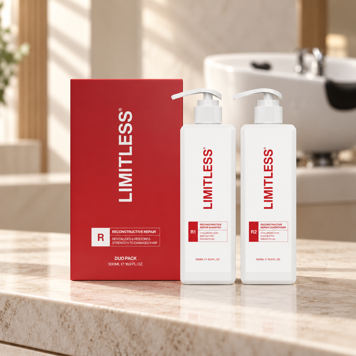 Limitless R1 Reconstructive Repair Shampoo and R2 Conditioner, 500ml each, with their red duo carton on a salon counter.