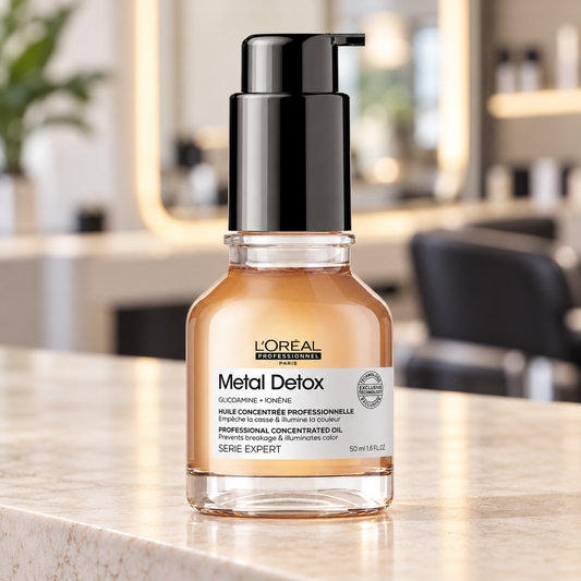 L’Oréal Professionnel Metal Detox Oil 50ml bottle on a salon styling counter.